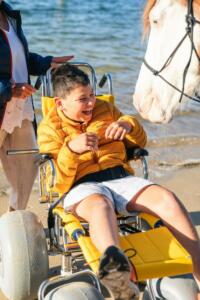 Boy sitting on Sandpiper smiling